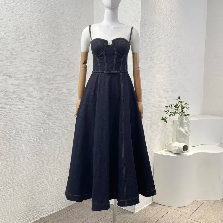 Black dress on a mannequin against a white wall